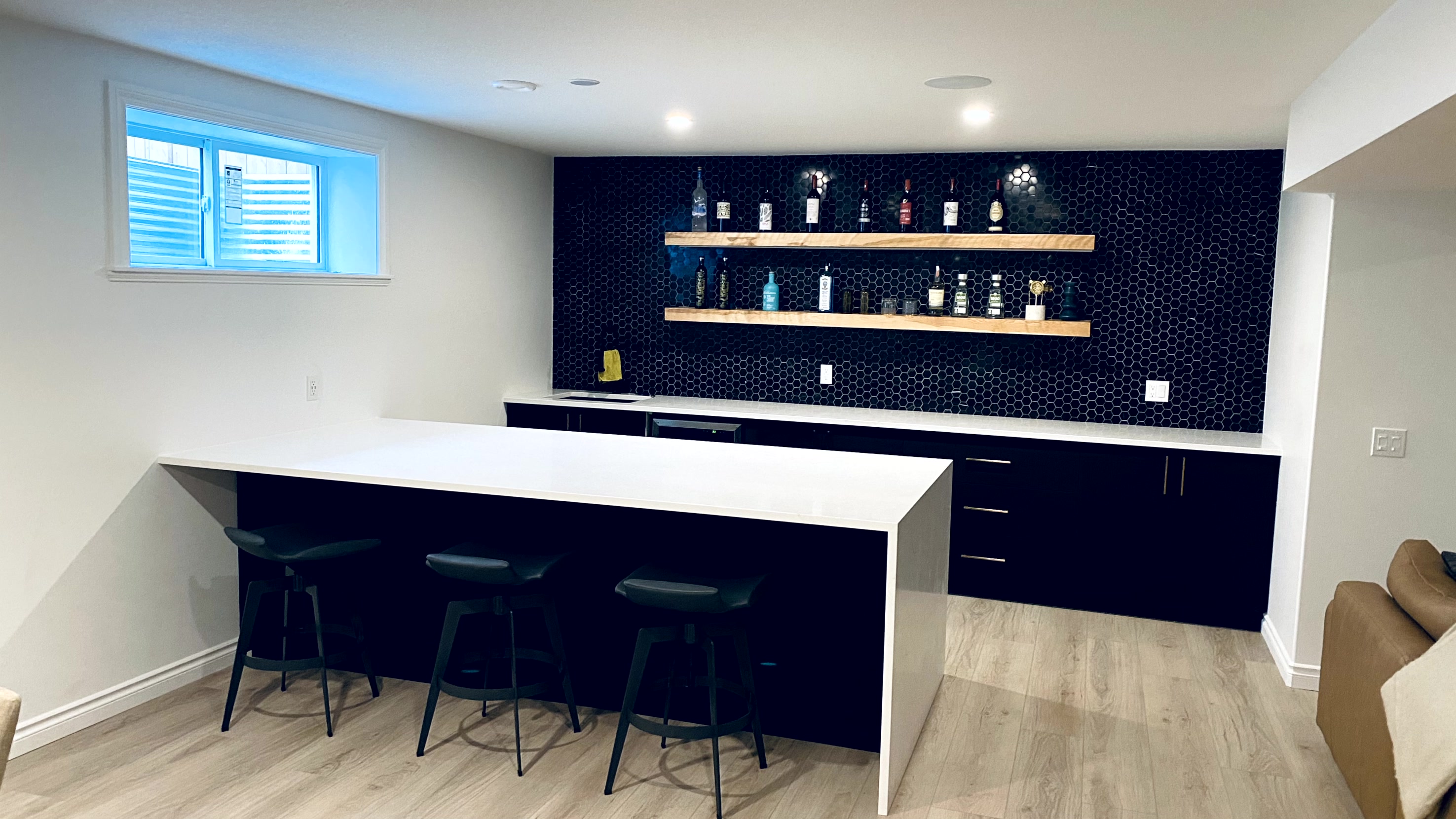 Solid wood floating shelves above a custom home bar in Edmonton